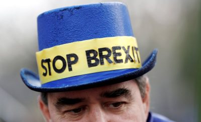A protester wears a ‘STOP BREXIT’ hat outside the Palace of Westminster, London